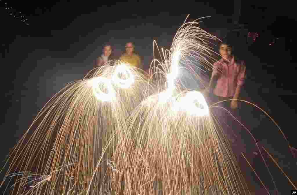 People set off fireworks to celebrate Diwali, Jammu, India, Nov. 3, 2013.