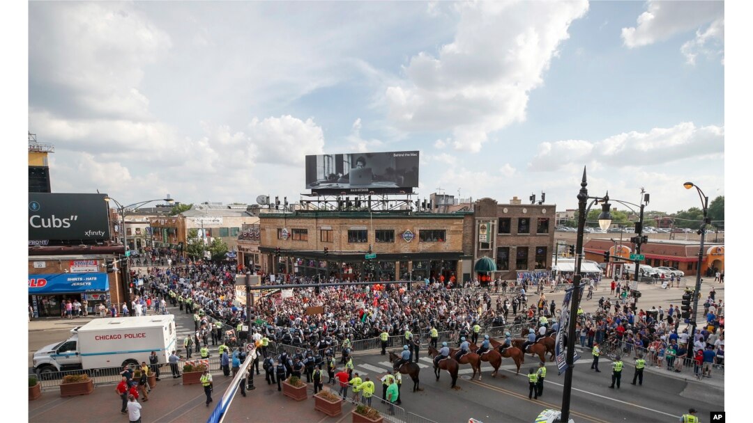Protesters arrive at Wrigley Field to demand more government action against gun violence, Aug. 2, 2018, in Chicago.