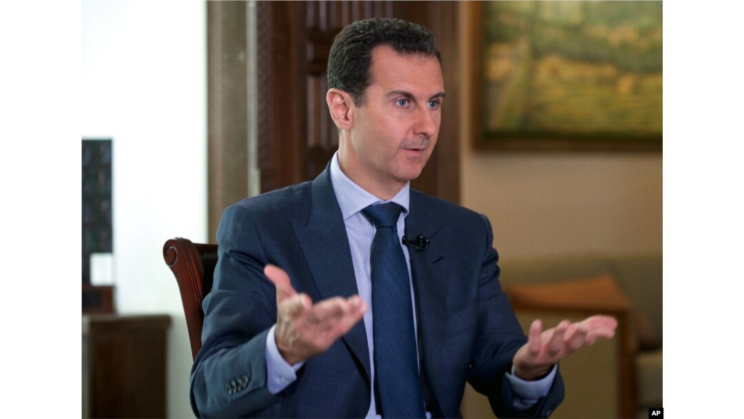 In this Wednesday, Sept. 21, 2016 photo released by the Syrian Presidency, Syrian President Bashar Assad speaks to The Associated Press at the presidential palace in Damascus, Syria.