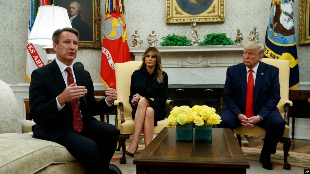 President Donald Trump and first lady Melania Trump listen as acting FDA Commissioner Ned Sharpless talks about a plan to ban most flavored e-cigarettes, in the Oval Office of the White House, Wednesday, Sept. 11, 2019, in Washington. (AP Photo/Evan Vucci
