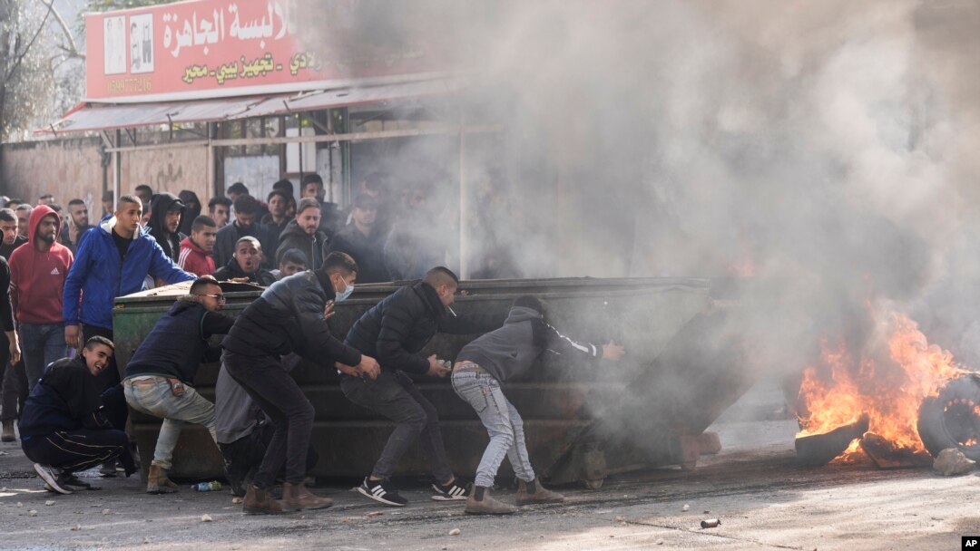 Palestinians clash with Israeli forces following an army raid in the West Bank city of Jenin, Jan. 26, 2023. Israeli forces killed at least nine Palestinians, including a 60-year-old woman, and wounded several others during a raid.