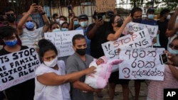 A group of people demonstrate against the government during a curfew, Sunday, April 3, 2022, in Colombo, Sri Lanka. (Eranga Jayawardena/AP)
