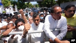 Sri Lankan opposition leader Sajith Premadasa, left, along with other opposition lawmakers, shout anti government slogans during a protest in Colombo, Sri Lanka, April 3, 2022. (Eranga Jayawardena/AP)