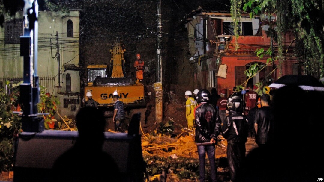 Rescue workers are seen at the site of a landslide in which a mother and six of her children were killed, in Paraty, Rio de Janeiro state, April 2, 2022.