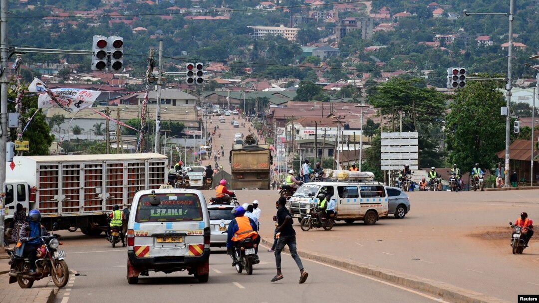 FILE - Motorists and cyclists are seen at a traffic light intersection amid the Ebola outbreak in Kampala, Uganda, Nov. 16, 2022.