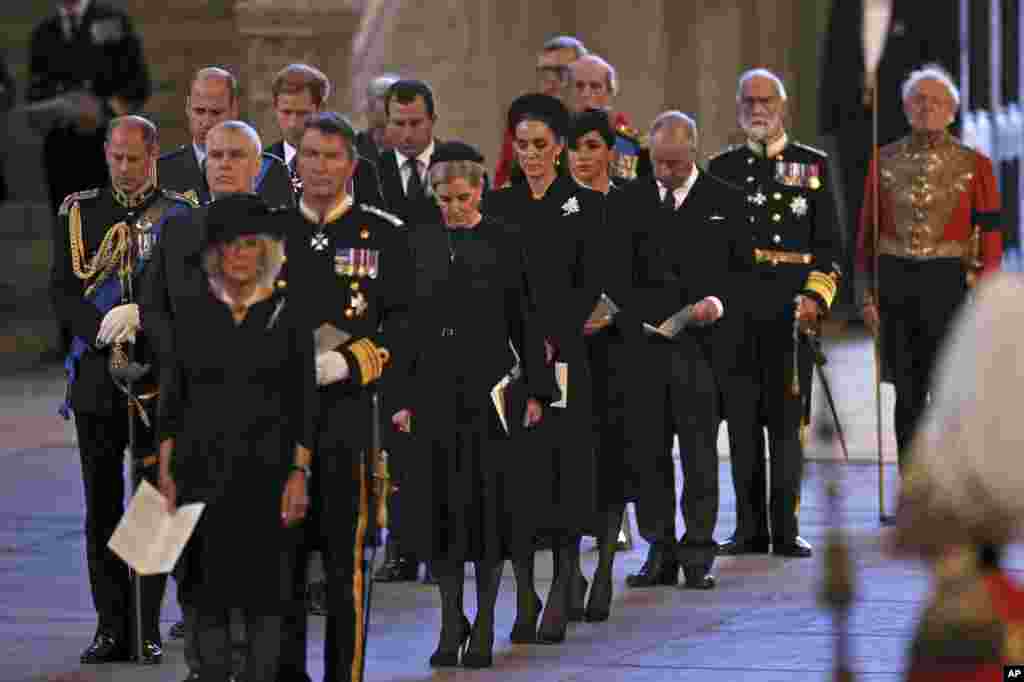 Camilla, Queen Consort, and other members of the Royal family stand inside the Palace of Westminster as Queen Elizabeth II lies in state in London, Sept. 14, 2022. 
