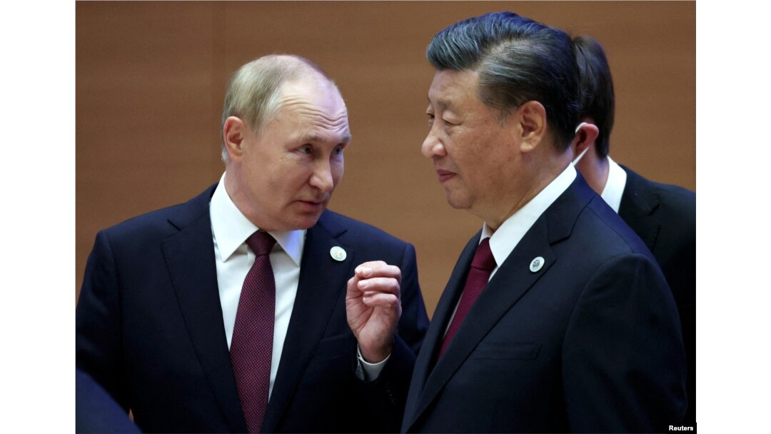 FILE - Russian President Vladimir Putin speaks with Chinese President Xi Jinping before an extended-format meeting of heads of the Shanghai Cooperation Organization summit (SCO) member states in Samarkand, Uzbekistan, Sept. 16, 2022. (Sputnik/Sergey Bobylev/Pool via Reuters)