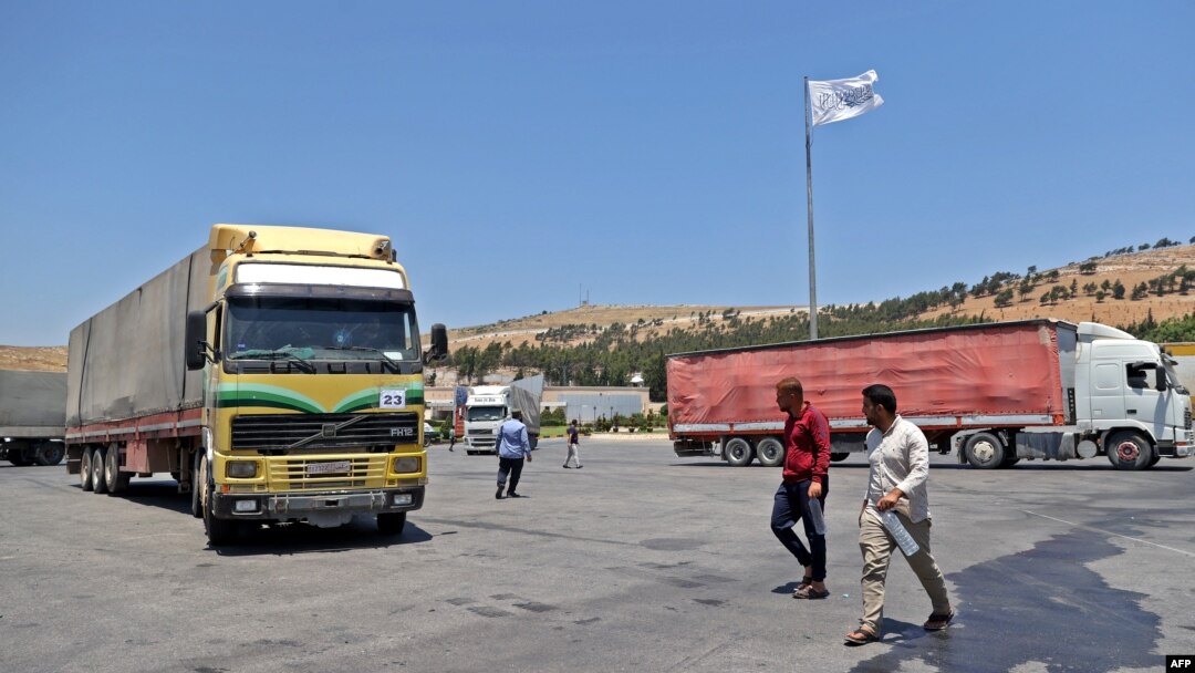A convoy transporting humanitarian aid crosses into Syria from Turkey through the Bab al-Hawa border crossing on July 8, 2022. 