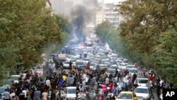 FILE - Protesters chant slogans during a protest over the death of a woman who was detained by the morality police, in downtown Tehran, Iran, Sept. 21, 2022, in this photo taken by an individual not employed by the Associated Press and obtained by the AP