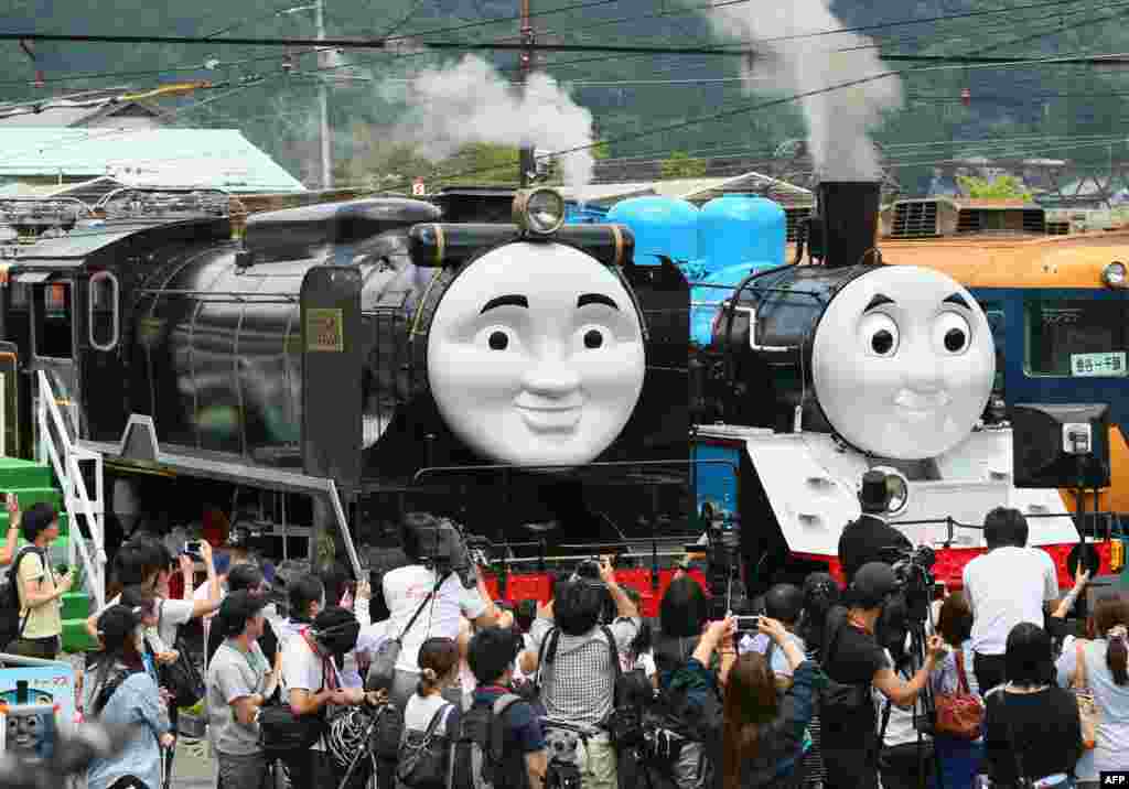 Life-sized Thomas the Tank Engine (R) and Hiro (L) are surrounded by the media, at Senzu station on Japan's Oigawa railway, in the town of Kawanehon in Shizuoka prefecture, west of Tokyo. Rides on popular British character Thomas the Tank Engine will be offered to the public from July 12 through Oct. 12 between Shinkanaya and Senzu stations.