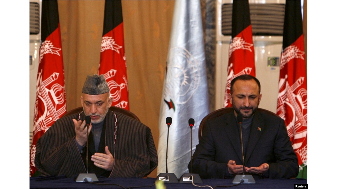 Former Afghan president Hamid Karzai, left, and former national security adviser Haneef Atmar, seen here offering prayers at a forum in Kabul, Feb. 12, 2008, are among influential Afghans expected to attend the Moscow talks.