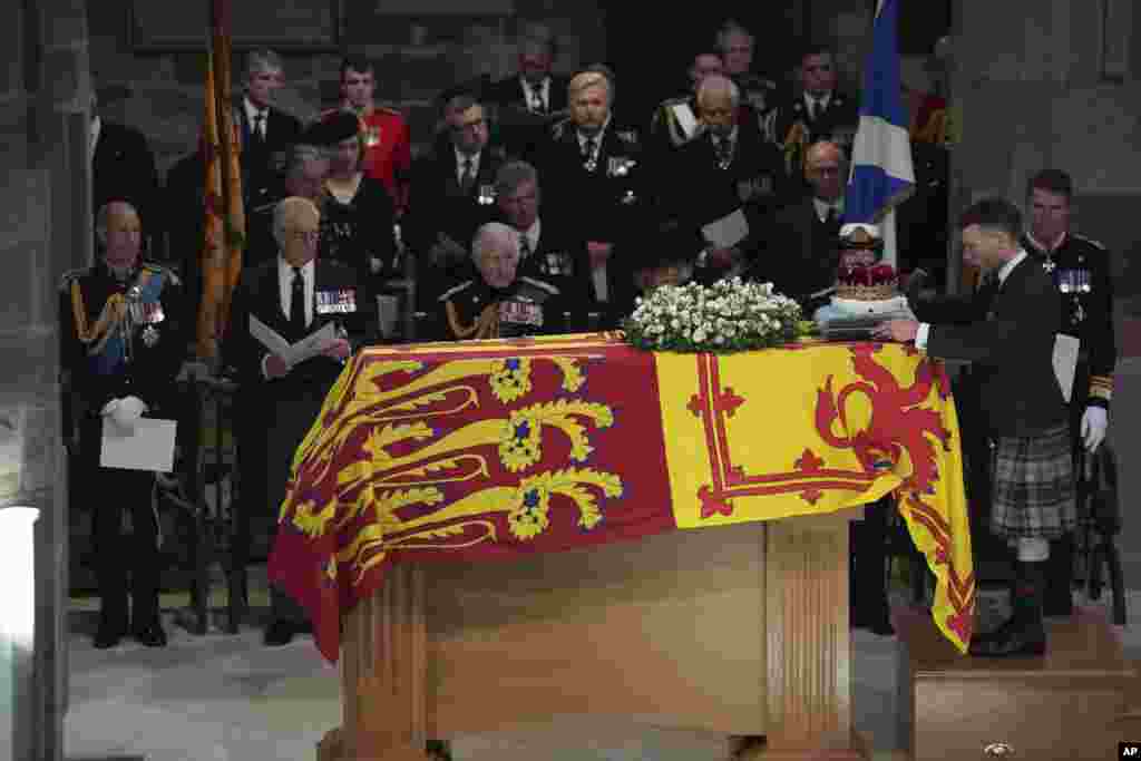 From left, Prince Edward, Prince Andrew, King Charles III, Camilla, the Queen Consort, Princess Anne and Vice Admiral Sir Tim Laurence, look on as the Duke of Hamilton places the Crown of Scotland on the coffin during the Service of Prayer and Reflection for the Life of Queen Elizabeth II at St. Giles' Cathedral, Edinburgh, Scotland.