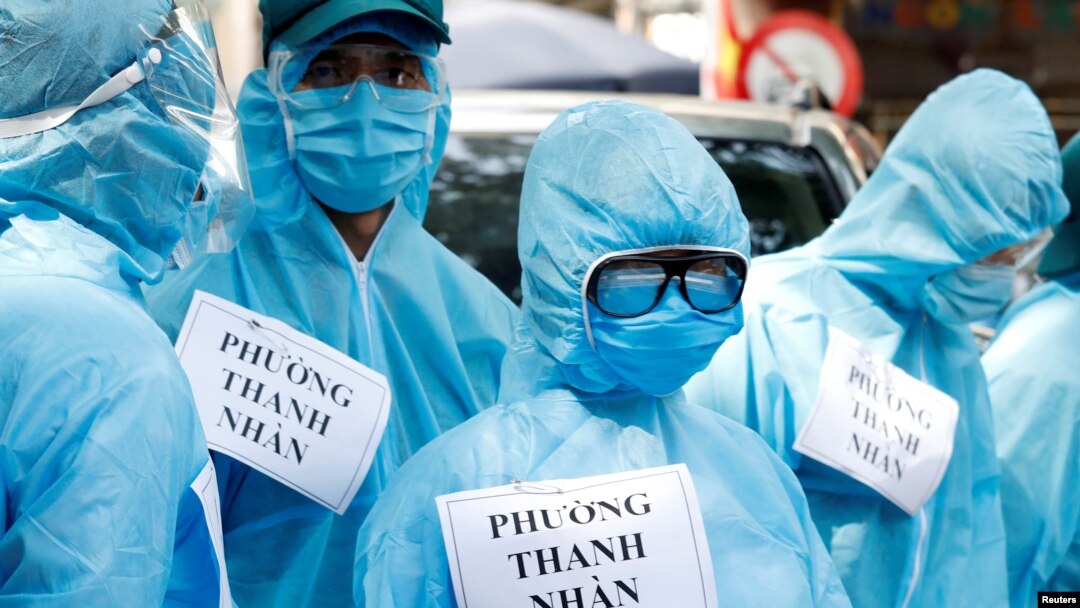 Medical healthcare workers wearing protective suits are seen at a testing center for COVID-19 in Hanoi, Vietnam, August 10, 2020.