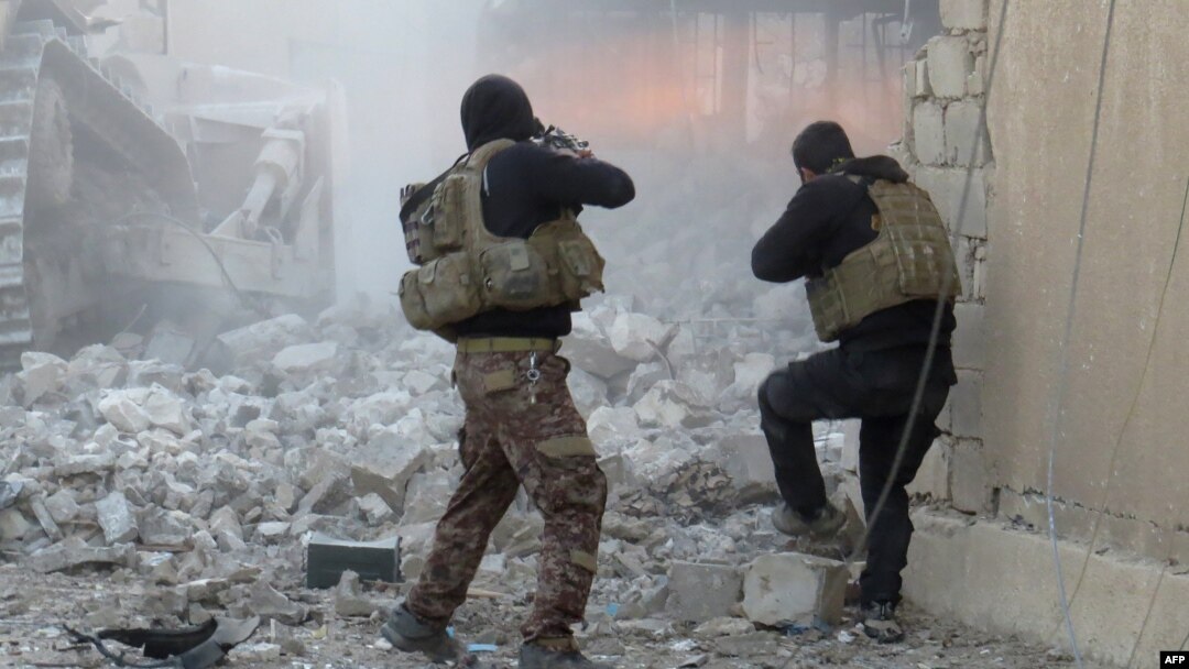 FILE - Iraqi forces secure an area in Ramadi, the capital of Iraq's Anbar province, on January 10, 2016, after retaking the city from Islamic State jihadists.