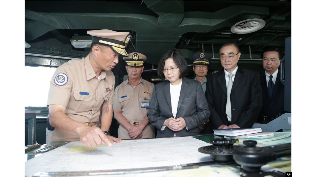 In this image taken and made available by the Taiwan Presidential Office, Taiwan's President Tsai Ing-wen (center right) reviews nautical charts aboard a Taiwan Navy ship before it sets out to patrol in the South China Sea.
