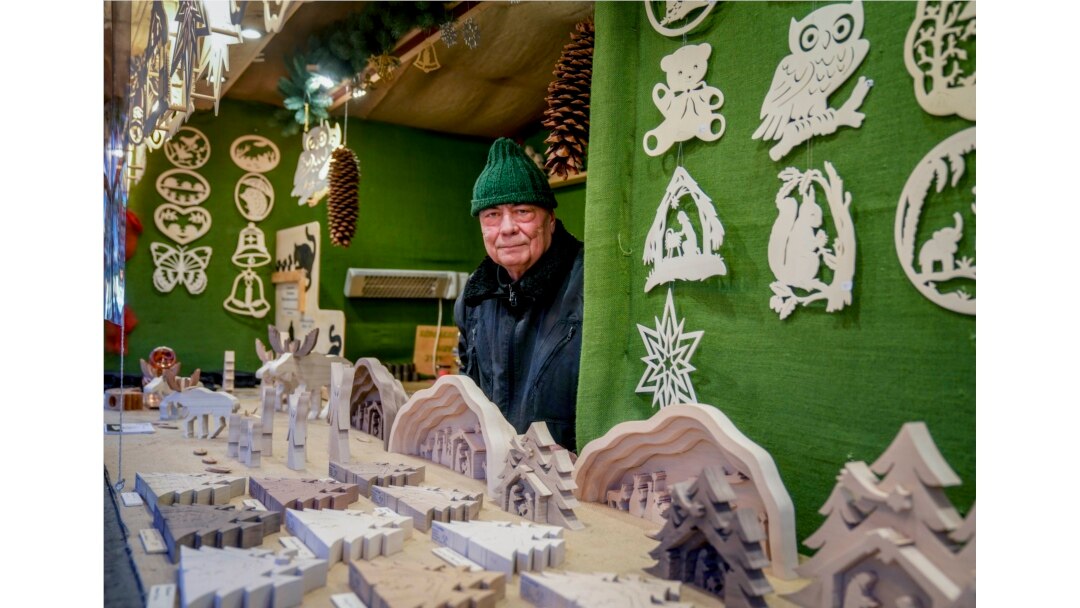 Vender Nils Knauerbstnads stands in his booth at the Christmas market in central Frankfurt, Germany, Nov. 23, 2021.