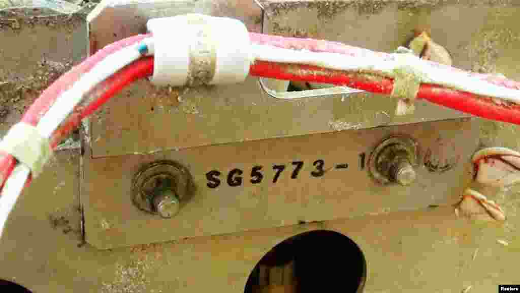 Details of a piece of suspected plane wreckage which has been found off the coast of southern Thailand is seen in Nakhon Si Thammarat province, Jan. 24, 2016.