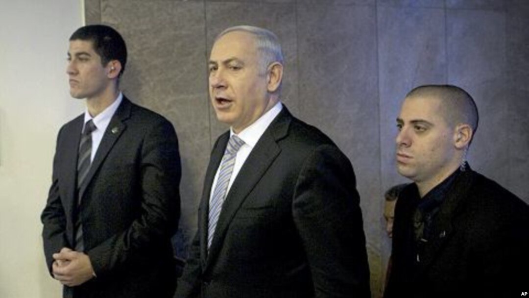 Israel's Prime Minister Benjamin Netanyahu, center, arrives at the weekly cabinet meeting in Jerusalem, February 5, 2012.