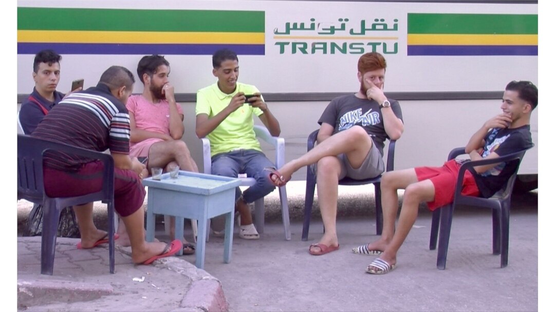 FILE - Young men are seen at a bus stop cafe in Tunis, Tunisia. Unemployment reaches 30 percent in some parts of Tunisia. (Lisa Bryant/VOA)