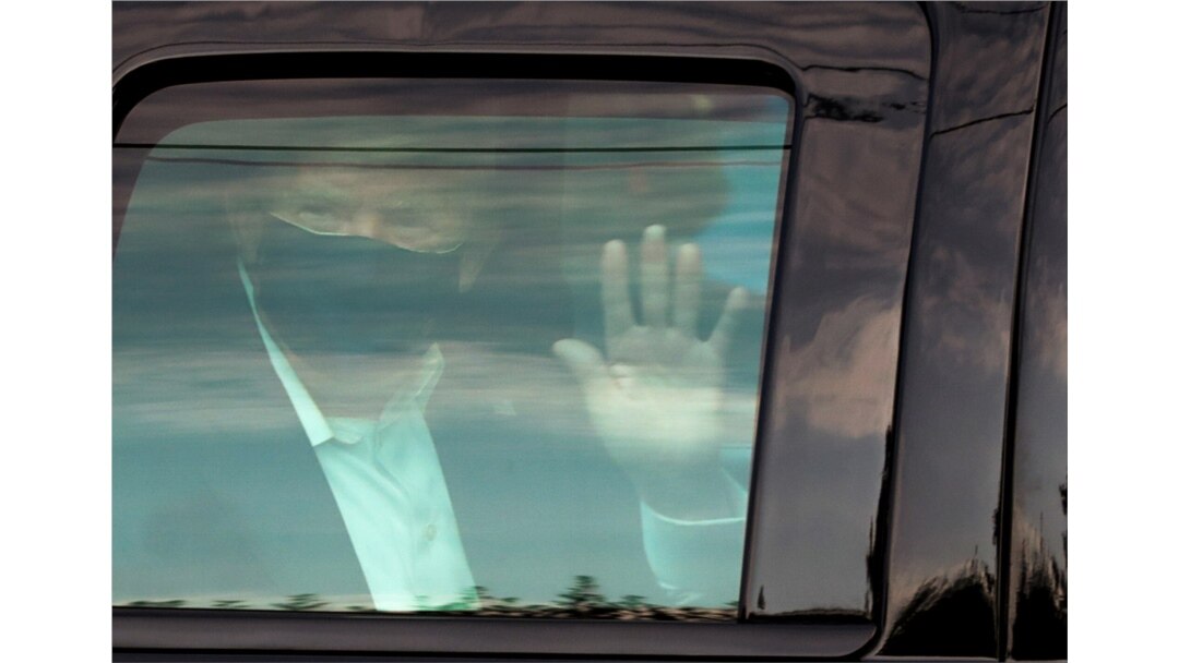 FILE PHOTO: FILE PHOTO: U.S. President Donald Trump waves to supporters outside of Walter Reed National Military Medical Center