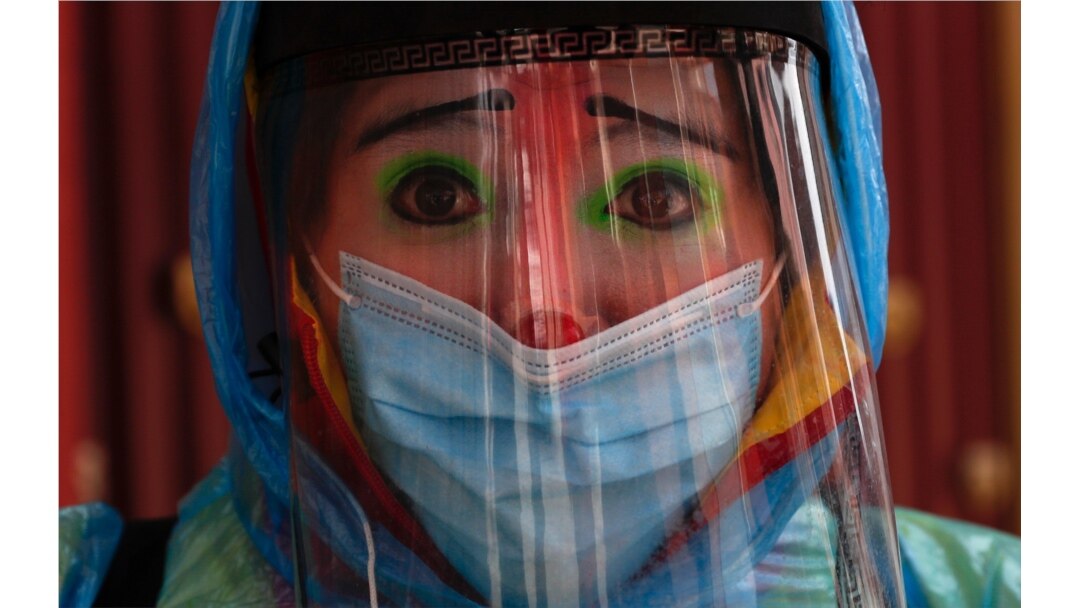 Clown Tapetito, wearing protective gear amid the new coronavirus, poses for a photo before disinfecting a home free of charge, in El Alto, Bolivia, Sept. 11, 2020.