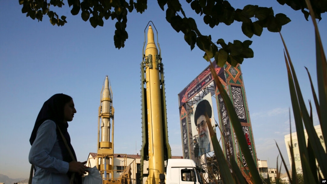 FILE - A Ghadr-H missle, center, a solid-fuel surface-to-surface Sejjil missile and a portrait of the Supreme Leader Ayatollah Ali Khamenei are on display at Baharestan Square in Tehran, Iran, Sept. 24, 2017.
