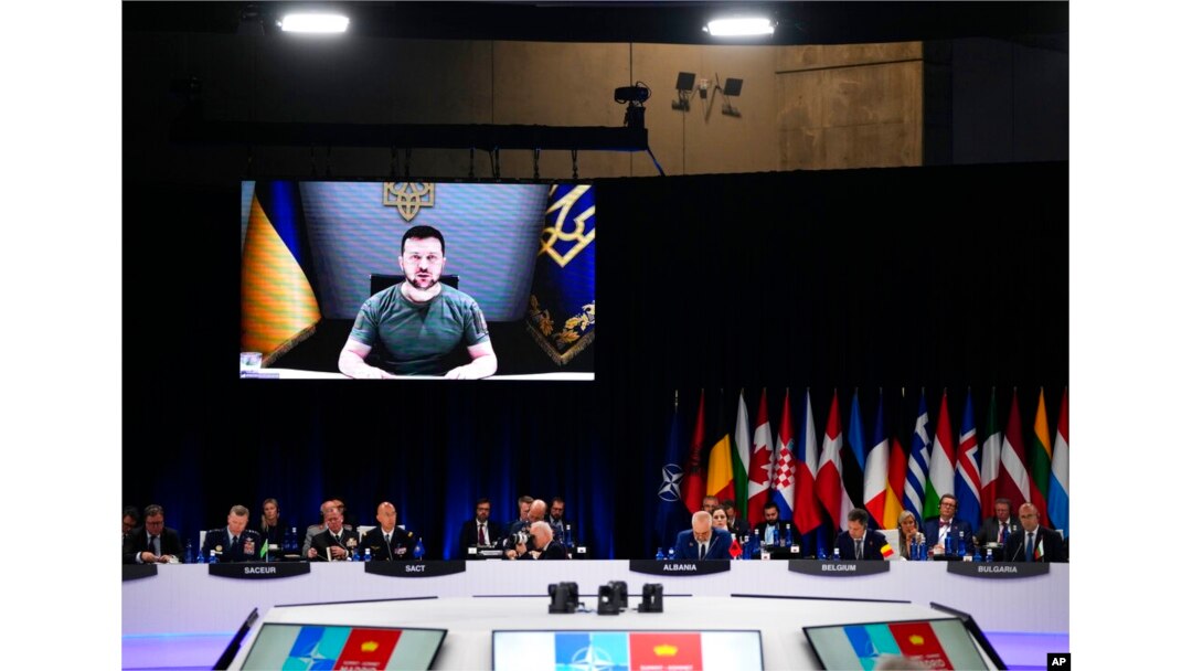 Ukraine's President Volodymyr Zelenskyy addresses leaders via a video screen during a roundtable meeting at a NATO summit in Madrid, Spain, June 29, 2022.