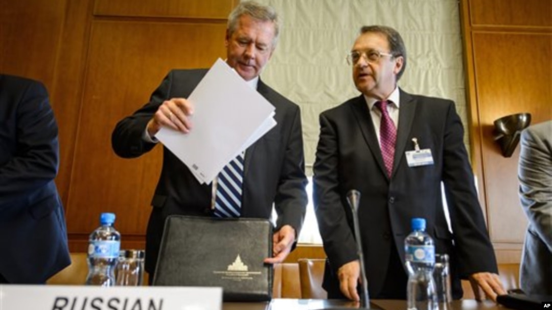 Russian Deputy Foreign Minister Gennady Gatilov (L) and Russian Deputy Foreign Minister Mikhail Bogdanov arrive at the United Nations office in a bid to organize the conference on Syria, in Geneva, June 2013.
