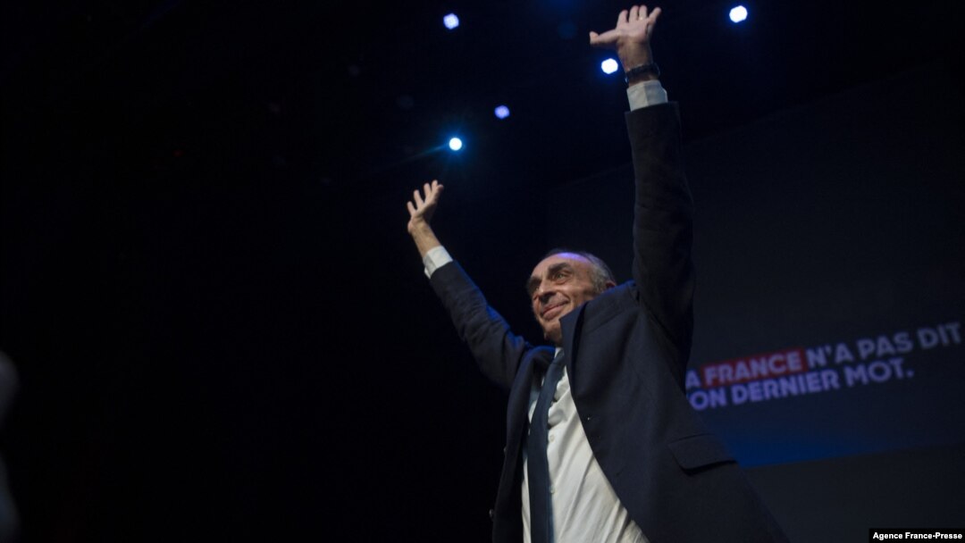 French far-right media pundit Eric Zemmour waves on stage before giving a speech as part of his promotional tour for his book 'France Hasn't Said Its Last Word' (La France n’a pas dit son dernier mot) in Beziers, southwestern France on Oct. 16, 2021.