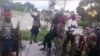 FILE - Image taken from militant video released by the Islamic State group on March 29, 2021, purporting to show fighters near the strategic north eastern Mozambique town of Palma.