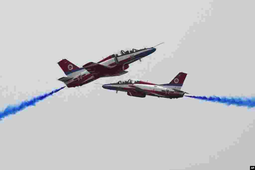Members of the Chinese People's Liberation Army (PLA) Air Force Aviation University's "Red Falcon" Air Demonstration Team perform during the 13th China International Aviation and Aerospace Exhibition, also known as Airshow China 2021, in Zhuhai in southern Guangdong province.