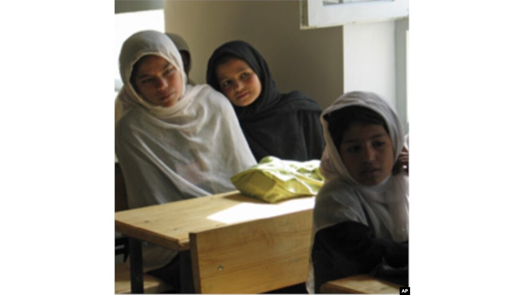 Afghan girls attend their first day of class at a school in the village of Deh Hassan.