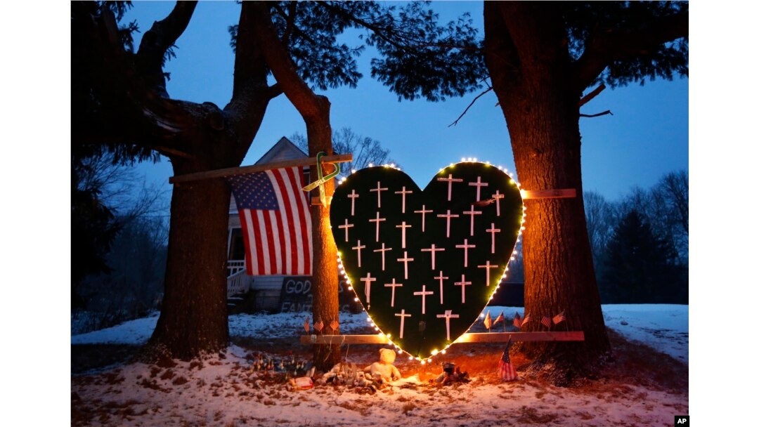 FILE - A makeshift memorial with crosses for the victims of the Sandy Hook massacre stands outside a home in Newtown, Dec. 14, 2013, the one-year anniversary of the shootings.