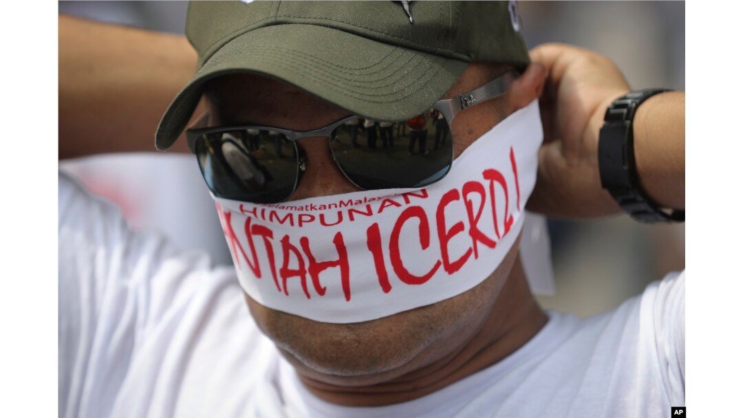 A protester covers his face with headbands reading "No to ICERD" during a rally to celebrate the government's decision not to ratify a U.N. anti-discrimination convention called ICERD at Independent Square in Kuala Lumpur, Malaysia, Dec. 8, 2018. ICERD stands for International Convention on the Elimination of All Forms of Racial Discrimination.