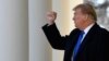 President Donald Trump gestures to the audience as he heads to the Oval Office after declaring a national emergency in order to build a wall along the southern border, Feb. 15, 2019, at the White House in Washington.