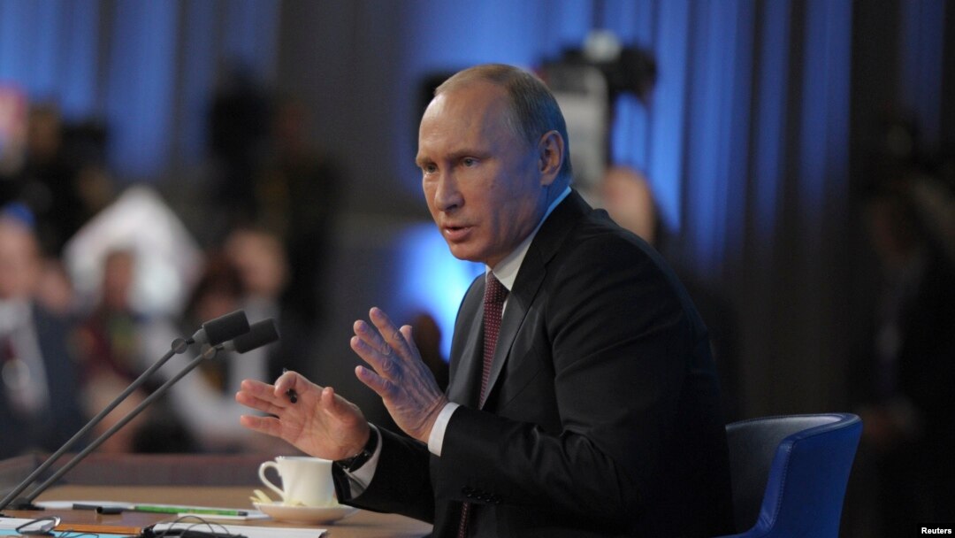 Russian President Vladimir Putin takes part in a televised news conference in Moscow, Dec. 19, 2013. 