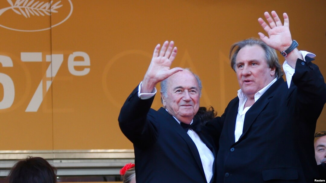 FILE - Actor Gerard Depardieu (R) and then-FIFA President Sepp Blatter pose on the red carpet for the screening of the film "United Passions" at the 67th Cannes Film Festival, May 18, 2014. 