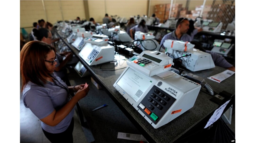 FILE - Electoral Court employees work on the final stage of sealing electronic voting machines in preparation for the general election run-off in Brasilia, Brazil, Oct. 19, 2022, ahead of the Oct. 30 second round vote.