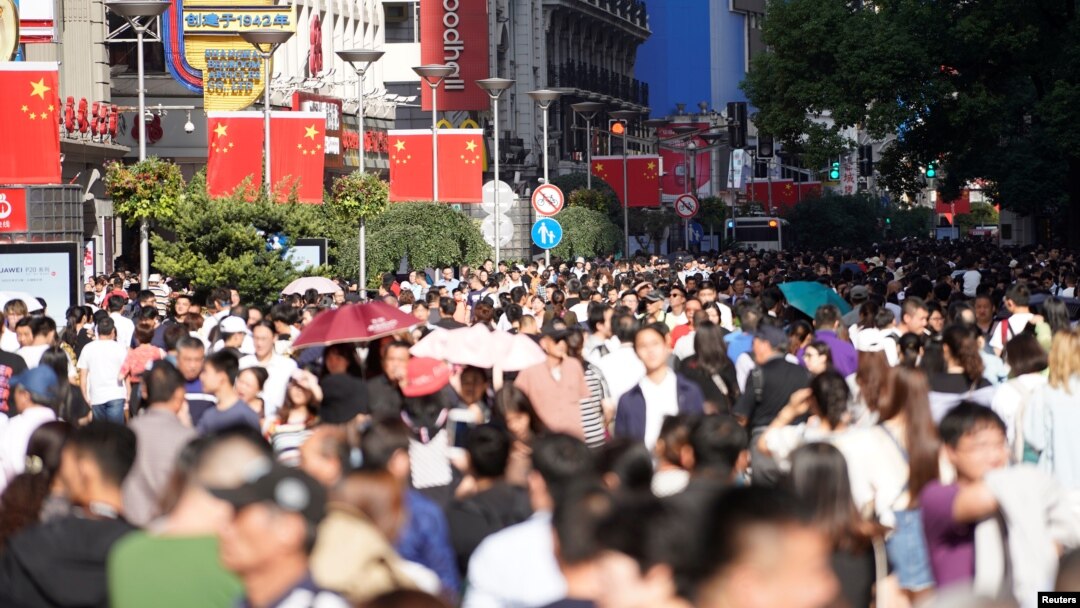 Chinese national flags are seen as tourists throng the Nanjing pedestrian road, a main shopping area, on China's 69th National Day in Shanghai, China, Oct. 1, 2018.