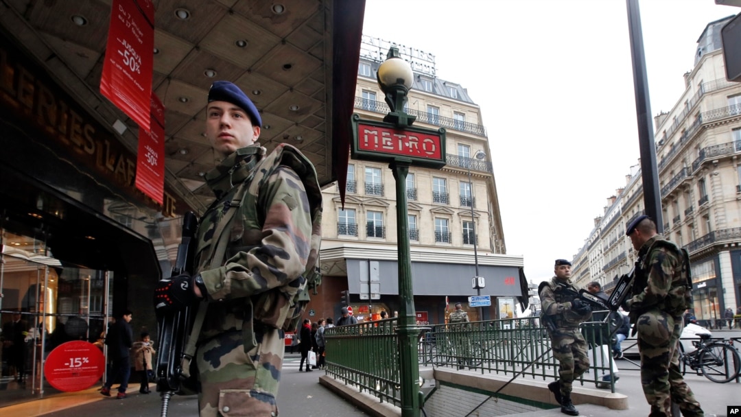 FILE - French soldiers patrol in Paris as part of heightened security following a deadly terrorist attack at satirical newspaper in January 2015.