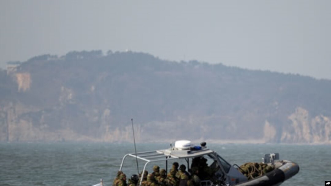South Korean navy sailors in a speed boat patrol around South Korea's western Yeonpyong Island after finishing their exercise, near the disputed sea border with North Korea, February 20, 2012.