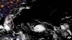 This photo provided by the National Oceanic and Atmospheric Administration shows a satellite view of Hurricane Dorian, taken at 10:00 p.m. EDT, Aug. 30, 2019.