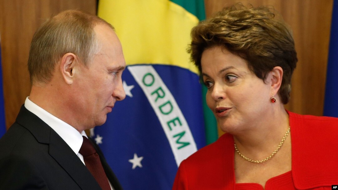 Russia's President Vladimir Putin, left, listens to Brazil's President Dilma Rousseff during a signing ceremony at Planalto presidential palace in Brasilia, Brazil, Monday, July 14, 2014.