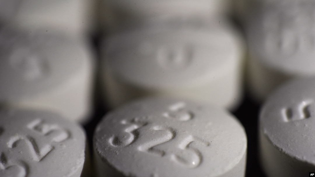 FILE - This Aug. 15, 2017, photo shows an arrangement of pills of the opioid oxycodone-acetaminophen in New York.