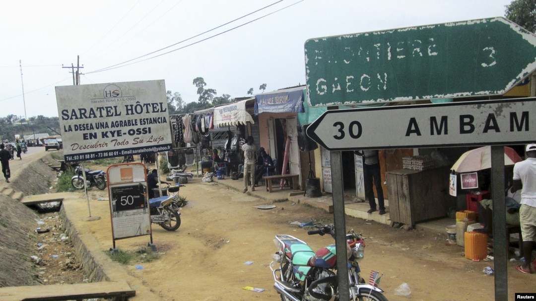 FILE - Signs are seen on the border with Equatorial Guinea and Gabon in Kye-Ossi, Cameroon, May 23, 2015.