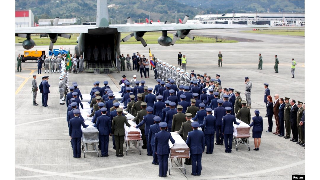 FILE - Military personnel unload a coffin with the remains of Brazilian victims who died in a plane crash in the Colombian jungle with Brazilian soccer team Chapecoense.