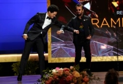 Host Trevor Noah, left, and Ringo Starr appear on stage at the 63rd annual Grammy Awards in Los Angeles, California, March 14, 2021. (AP Photo/Chris Pizzello)