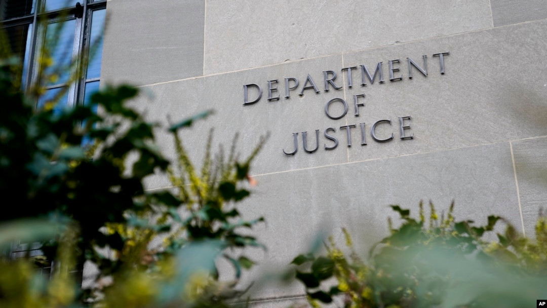 FILE - Signage marks an exterior wall of the U.S. Department of Justice Building in Washington, Jan. 23, 2023. 