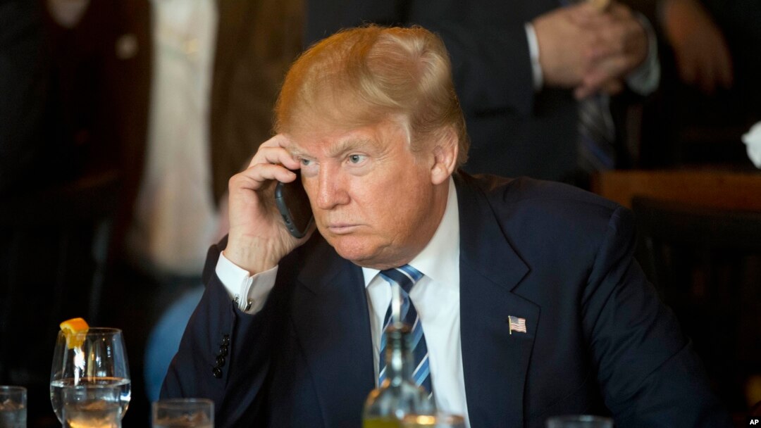FILE - Then-Republican presidential candidate Donald Trump uses his mobile phone during a lunch stop in North Charleston, S.C., Feb. 18, 2016. The president took to Twitter July 29, 2017, to criticize Republican senators.