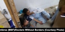 FILE - Doctors Without Borders Staff in shock in part of the international medical charity's hospital in Kunduz, Afghanistan, that wasn't destroyed by an apparent airstrike, Oct. 3, 2015.
